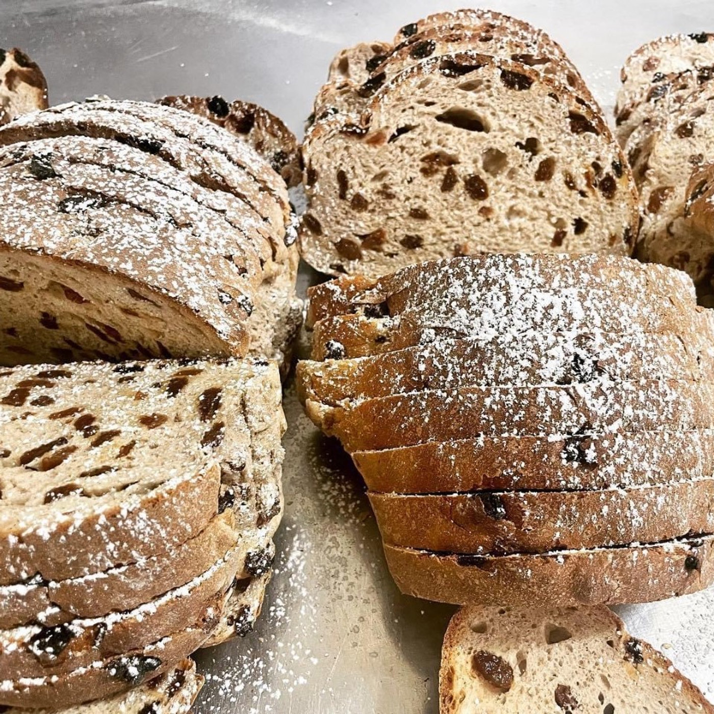 Sliced Dutch fruit loaf dusted with icing sugar