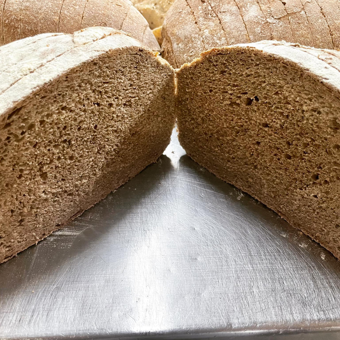 Rye and caraway sourdough halves showing the dense crumb