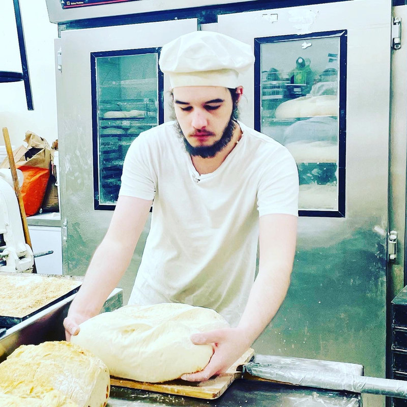 Travis shaping a round of dough